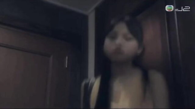 Asian girl in yellow top by door in BDSM scene thumbnail