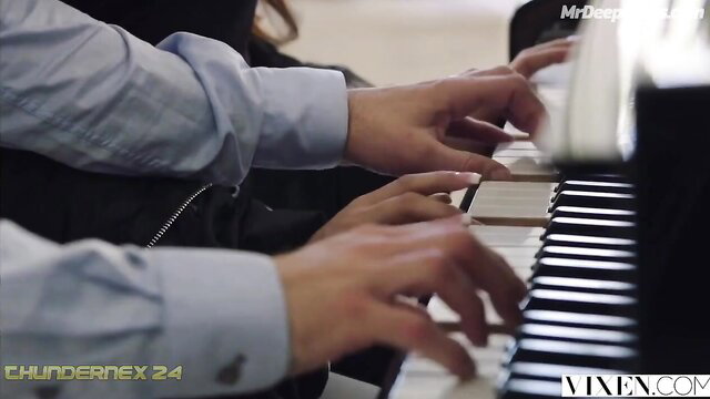 Man's hands playing piano with woman's beside in Deepika Padukone scene