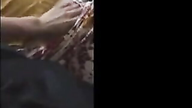 Aunty in a sensual pose with her hand on a person's head