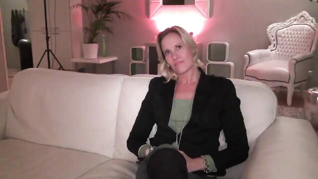 Blonde MILF Celine in blazer teases with dirty talk on couch
