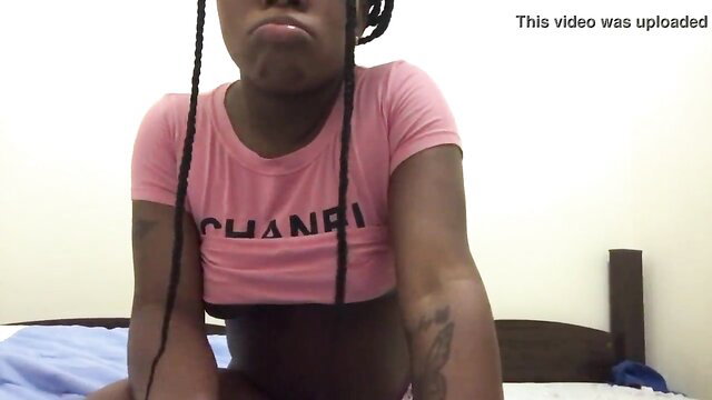 Hot black babe in pink Chanel crop top with braids, sexy pout on bed