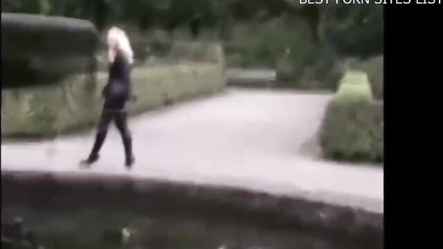 Blonde German Fetish Lady Vanessa walks in tight leather pants outdoors