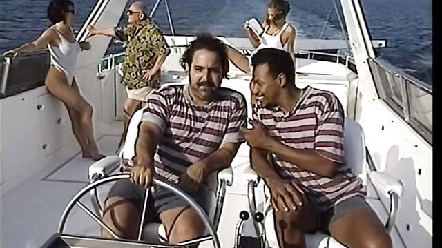 Vintage 90s boat party with bikini babes, hairy guys steering yacht