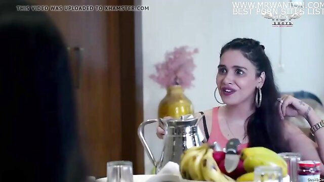 Hot Indian babe in pink top smiles at table with bananas, Love Lust web series