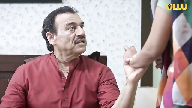 Indian mature man holds young woman's arm in erotic scene