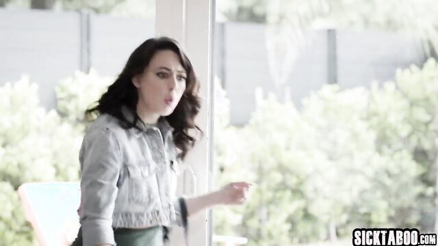 Woman looking out the window with a shocked expression, wearing a denim jacket