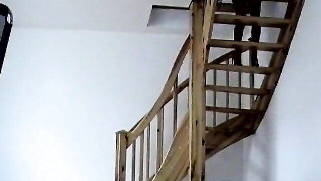 Hot girlfriend modeling on spiral stairs in tight dress