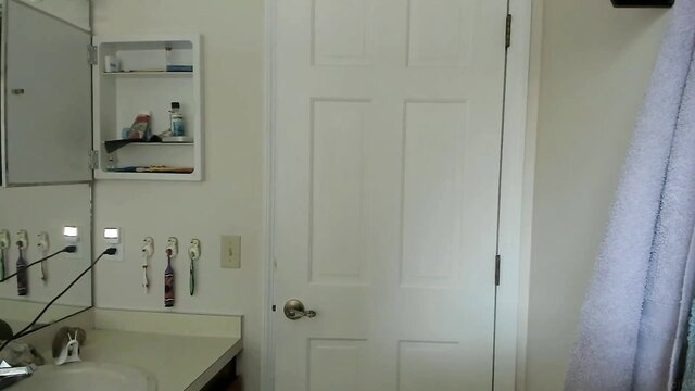 Kelly Payne in bathroom with toiletries and white door