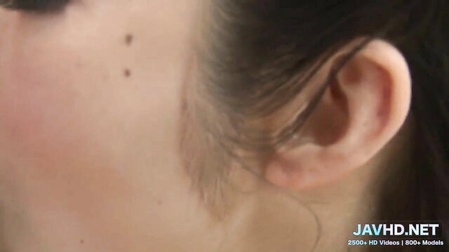 Closeup of sexy Asian woman's face with beauty mark, JAV hot lips tease