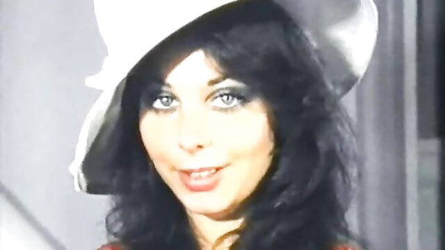 Vintage brunette with big blue eyes in white hat smiles seductively