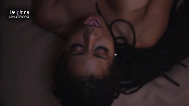 Kira Noir topless on bed, seductive gaze in Delphine hotel scene