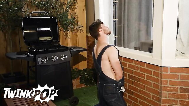 Finn Harding in overalls bends over by grill in hot twink scene
