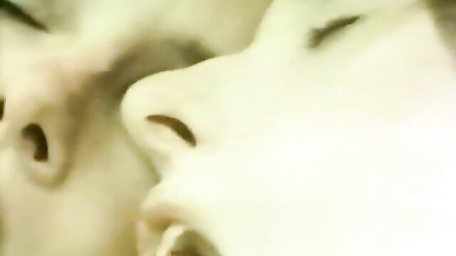 Vintage 1976 porn closeup of two women kissing passionately