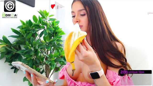 Anyarayne eats banana seductively, topless in pink off-shoulder top