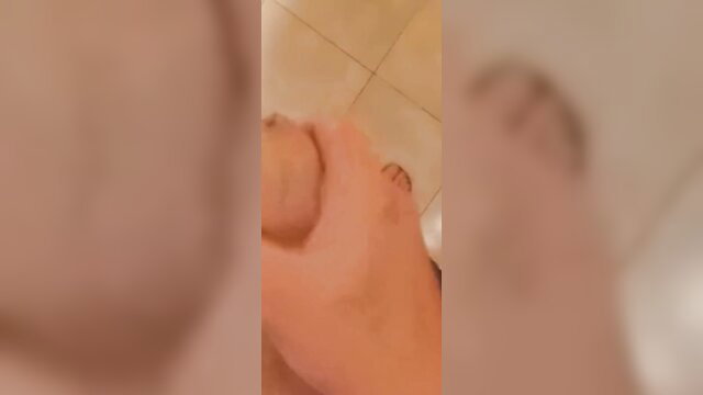 Ariel19969 holds uncircumcised cock and shows foot in shower