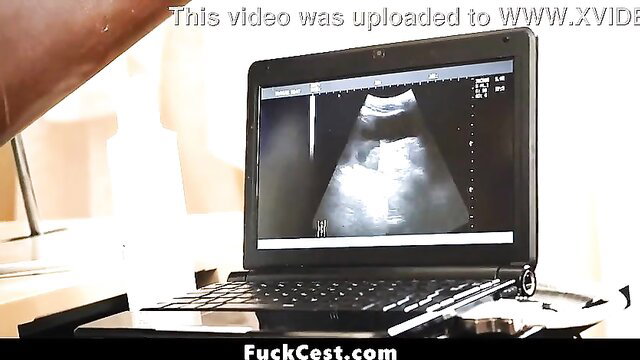 Ultrasound on laptop screen in dimly lit room, adult video thumbnail