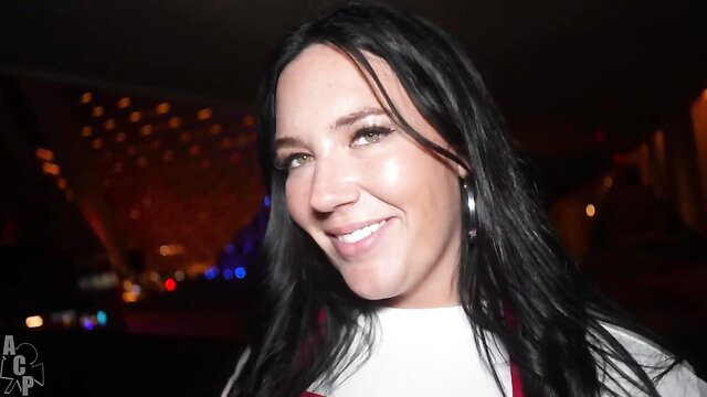 Alex Blair smiling at night event, black hair, hoop earrings