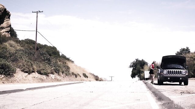Kristen Scott as grateful hitchhiker by broken Jeep on roadside