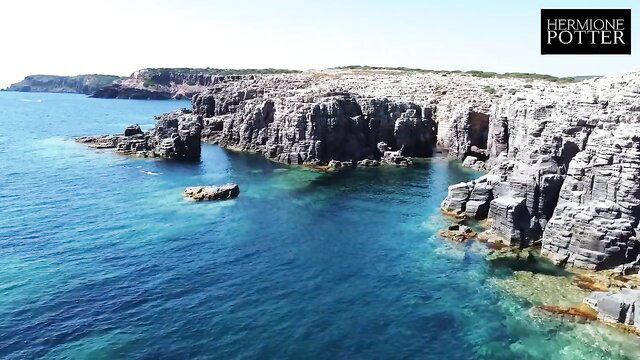 Hermione Potter on stunning Sardinian cliffs, adult travel vlog tease