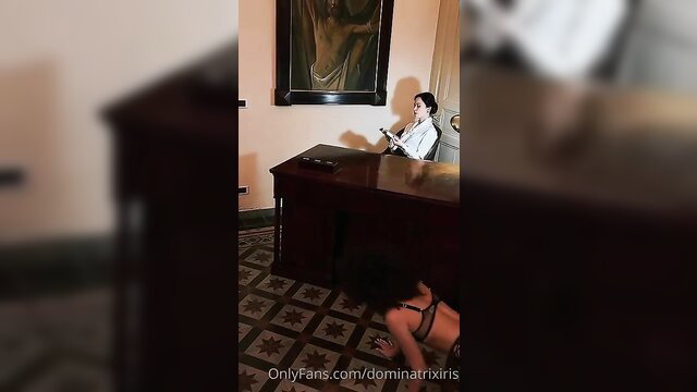 Italian mistress in white blouse dominates sub in lingerie under desk