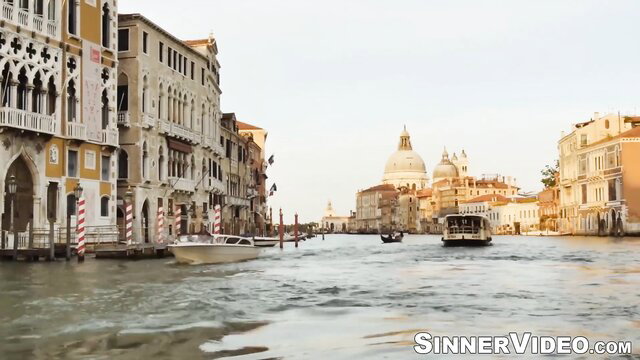 Venice canal view with boats and historic buildings at dusk