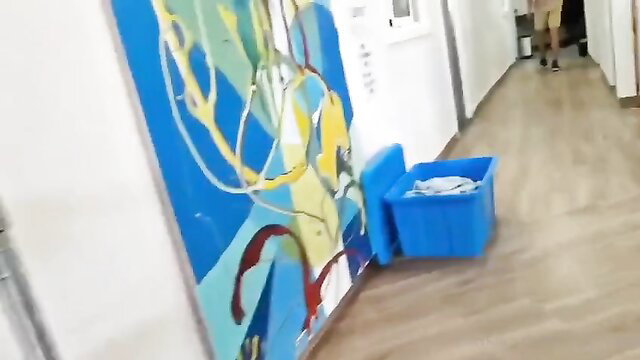 Candid hostel hallway scene with blue bin and plates