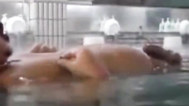 Japanese sauna babe nude in steamy hot tub, wet skin glistening