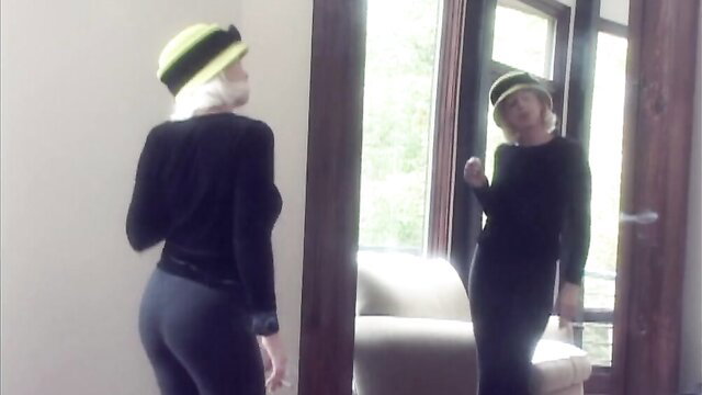 Hailey H in tight black dress and yellow hat, sexy mirror pose