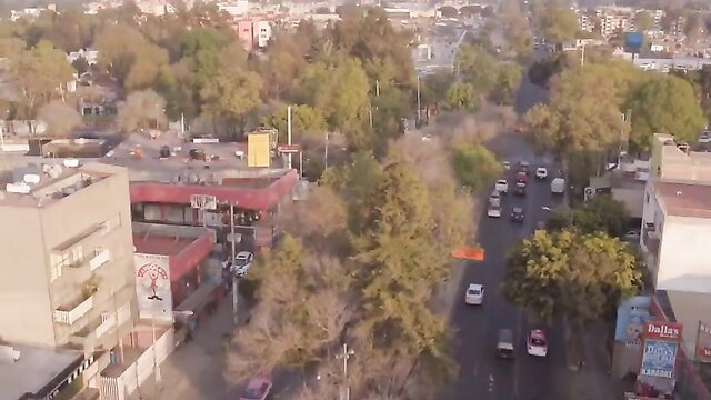 Aerial view of Mexican street with cars and buildings in El Sexoservidor 4