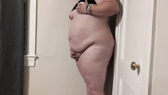 Aura Flowers nude pregnant side pose against wall