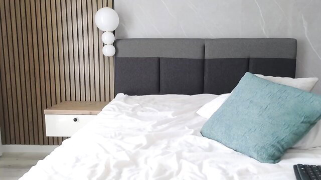 SaraDimond on bed in MyFreeCams stream, sexy teal pillow tease
