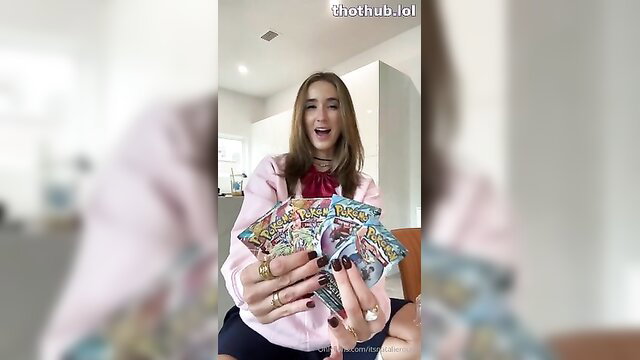 Natalie Roush sexy Pokemon cosplay holding card packs, pink blouse