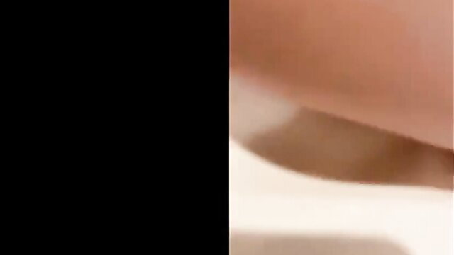 Uncensored closeup of woman's wet pink pussy lips spread wide