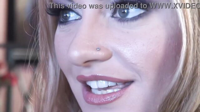Talia Palmer closeup smiling with glossy lips and nose piercing