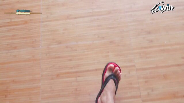 Closeup of woman's red flip-flop foot on floor before anal creampie