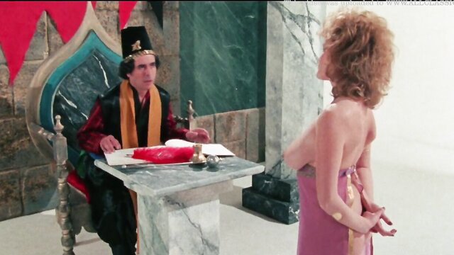 Blonde big tits babe in pink dress before robed sultan in erotic Arabian Nights porn