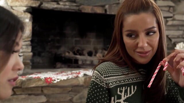Vanna Bardot in sexy green reindeer sweater licks candy by fireplace