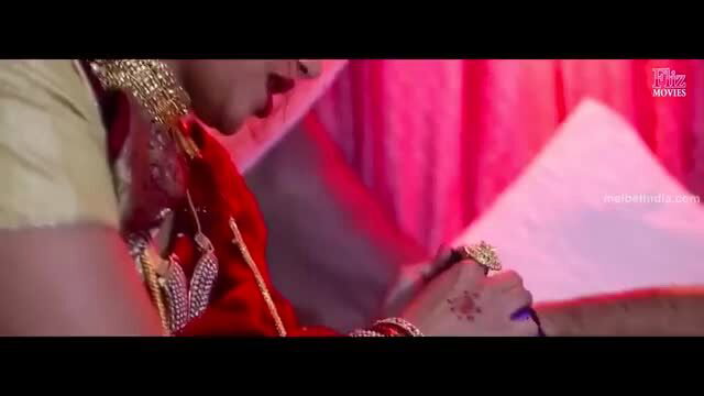 Busty Indian bride in red saree with henna hands and gold jewelry