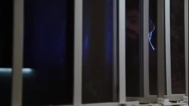 Monica Mattos nude behind bars, Ju Calaf topless in blue-lit erotic scene
