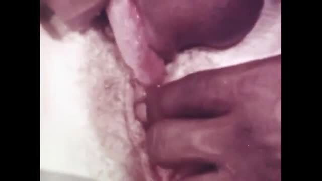 Vintage closeup of black woman with tongue out, wet pussy spread by hand