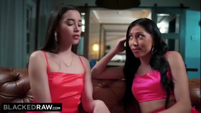 Two Asian women in pink lingerie sitting on couch in adult scene