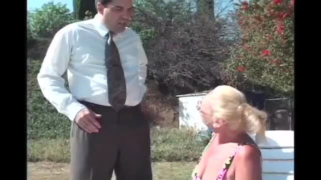 Blonde MILF in outdoor scene with suited man