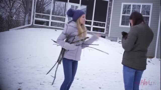 Scarlett Sage and Shyla Jennings in winter coats playing in snow
