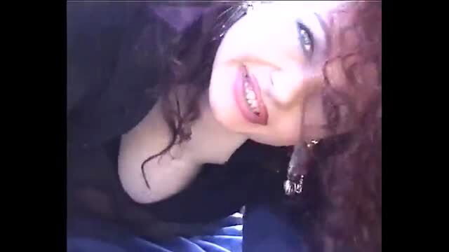 Jessica Rizzo smiling in black top with curly red hair