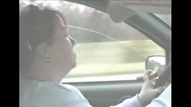 Mature woman smoking a huge cigar while driving in car