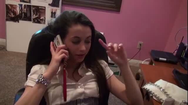 Georgia Jones on phone call, brunette wearing white shirt and watch