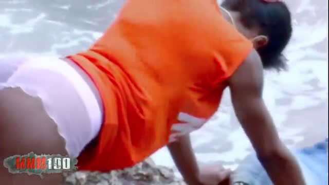 Ebony babe in orange shirt getting fucked doggy style on the beach