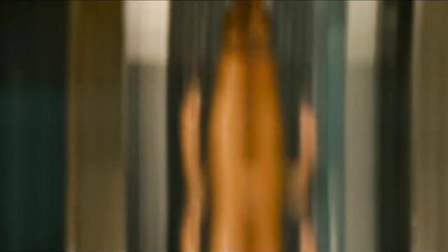 Rosario Dawson nude rear view with long red hair, sexy blurred pose