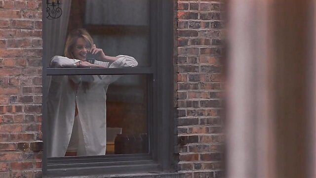 Elle Macpherson leaning out window in open white blouse, If Lucy Fell