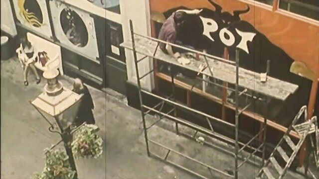 Vintage interracial taboo painter on scaffolding with bold POT letters